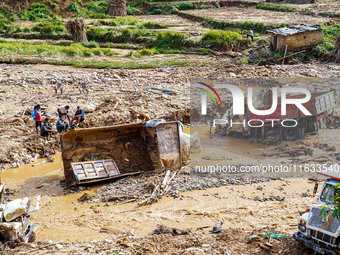 Flooding from the Salamdo River sweeps and damages a vehicle in Patikharka, Kavrepalanchok District, Nepal, on October 3, 2024. (