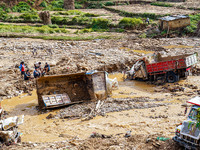 Flooding from the Salamdo River sweeps and damages a vehicle in Patikharka, Kavrepalanchok District, Nepal, on October 3, 2024. (