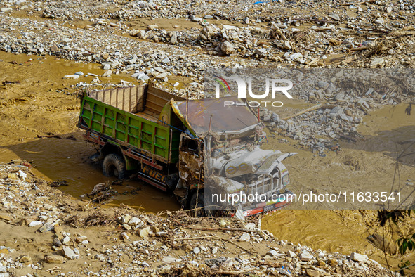 Flooding from the Salamdo River sweeps and damages a vehicle in Patikharka, Kavrepalanchok District, Nepal, on October 3, 2024. 