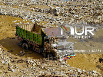 Flooding from the Salamdo River sweeps and damages a vehicle in Patikharka, Kavrepalanchok District, Nepal, on October 3, 2024. (