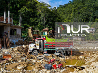 Flooding from the Salamdo River sweeps and damages a vehicle in Patikharka, Kavrepalanchok District, Nepal, on October 3, 2024. (