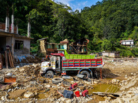 Flooding from the Salamdo River sweeps and damages a vehicle in Patikharka, Kavrepalanchok District, Nepal, on October 3, 2024. (