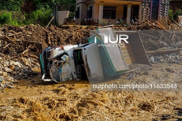 Flooding from the Salamdo River sweeps and damages a vehicle in Patikharka, Kavrepalanchok District, Nepal, on October 3, 2024. 