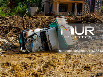 Flooding from the Salamdo River sweeps and damages a vehicle in Patikharka, Kavrepalanchok District, Nepal, on October 3, 2024. (