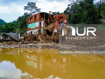 Salamdo River flooding damages homes in Patikharka of Kavrepalanchok District, Nepal, on October 3, 2024. Homes are severely damaged, with m...