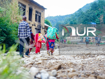 Due to heavy rainfall, the Salamdo River flood damages the road in Patikharka, Kavrepalanchok District, Nepal, on October 3, 2024. People ha...