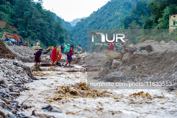 Due to heavy rainfall, the Salamdo River flood damages the road in Patikharka, Kavrepalanchok District, Nepal, on October 3, 2024. People ha...