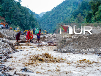 Due to heavy rainfall, the Salamdo River flood damages the road in Patikharka, Kavrepalanchok District, Nepal, on October 3, 2024. People ha...