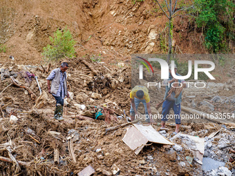 People search for their belongings in damaged houses due to Salamdo River flooding in Patikharka of Kavrepalanchok District, Nepal, on Octob...