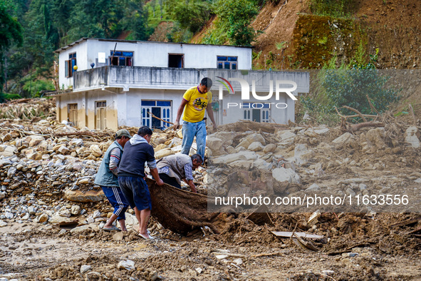 People search for their belongings in damaged houses due to Salamdo River flooding in Patikharka of Kavrepalanchok District, Nepal, on Octob...