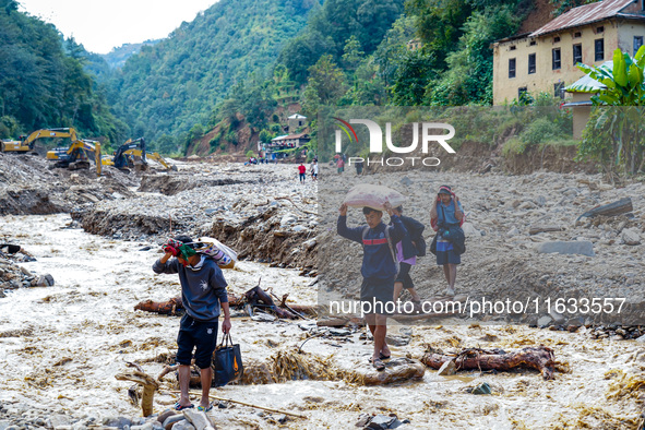 Due to heavy rainfall, the Salamdo River flood damages the road in Patikharka, Kavrepalanchok District, Nepal, on October 3, 2024. People re...