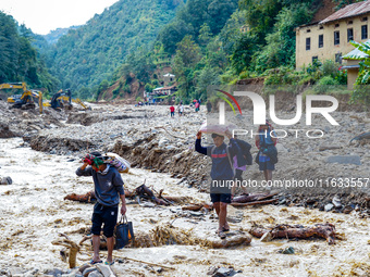 Due to heavy rainfall, the Salamdo River flood damages the road in Patikharka, Kavrepalanchok District, Nepal, on October 3, 2024. People re...