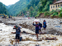 Due to heavy rainfall, the Salamdo River flood damages the road in Patikharka, Kavrepalanchok District, Nepal, on October 3, 2024. People re...