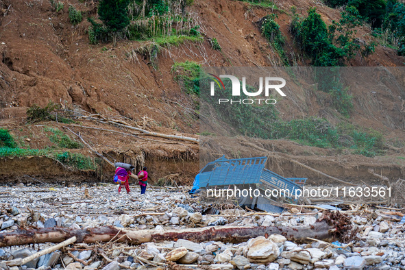 Due to heavy rainfall, the Salamdo River flood damages the road in Patikharka, Kavrepalanchok District, Nepal, on October 3, 2024. People ha...