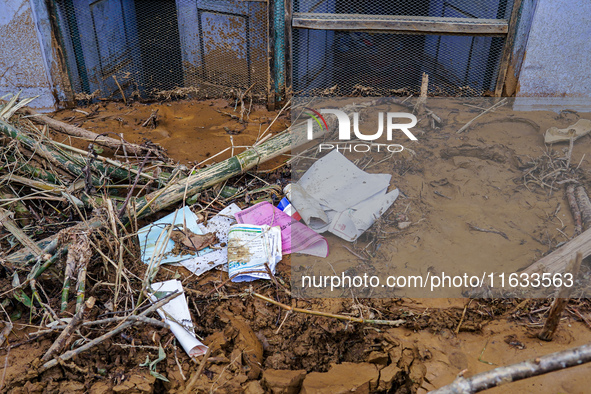 Scattered papers lie in front of damaged homes in Patikharka, Kavrepalanchok District, Nepal, on October 3, 2024. 