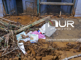 Scattered papers lie in front of damaged homes in Patikharka, Kavrepalanchok District, Nepal, on October 3, 2024. (