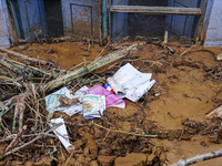 Scattered papers lie in front of damaged homes in Patikharka, Kavrepalanchok District, Nepal, on October 3, 2024. (