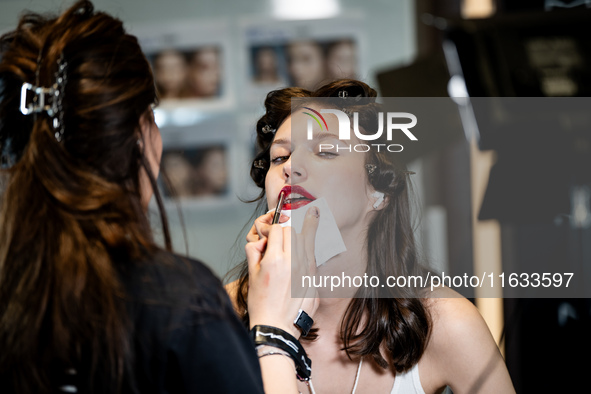 Models get ready backstage before walking on the runway during Day 2 of Bangkok International Fashion Week at Siam Paragon in Bangkok, Thail...