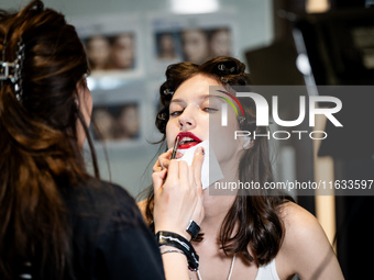 Models get ready backstage before walking on the runway during Day 2 of Bangkok International Fashion Week at Siam Paragon in Bangkok, Thail...