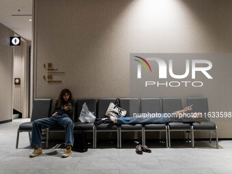 Models take a break backstage before walking on the runway during Day 2 of Bangkok International Fashion Week at Siam Paragon in Bangkok, Th...