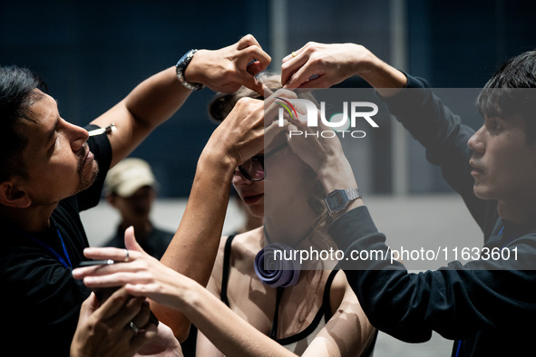 Models get ready backstage before walking on the runway during Day 2 of Bangkok International Fashion Week at Siam Paragon in Bangkok, Thail...