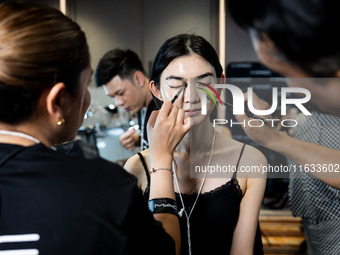 Models get ready backstage before walking on the runway during Day 2 of Bangkok International Fashion Week at Siam Paragon in Bangkok, Thail...