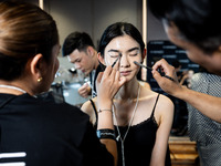 Models get ready backstage before walking on the runway during Day 2 of Bangkok International Fashion Week at Siam Paragon in Bangkok, Thail...