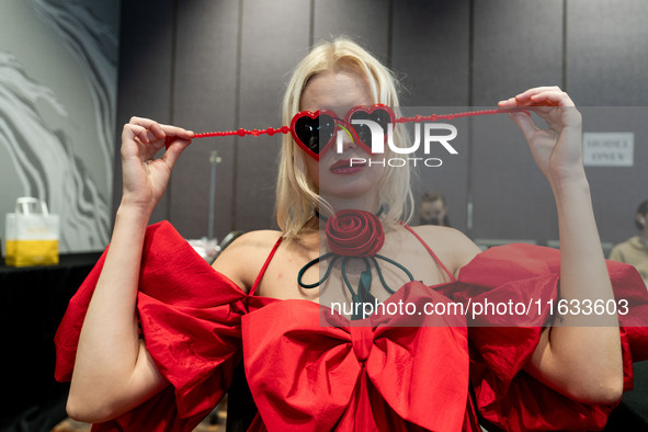 Models get ready backstage before walking on the runway during Day 2 of Bangkok International Fashion Week at Siam Paragon in Bangkok, Thail...