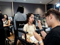 Linda, a young Thai twin, gets ready backstage before walking on the runway during Day 2 of Bangkok International Fashion Week at Siam Parag...