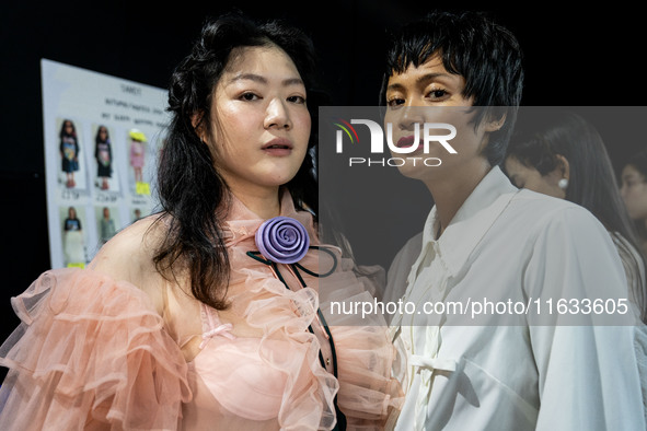 Models get ready backstage before walking on the runway during Day 2 of Bangkok International Fashion Week at Siam Paragon in Bangkok, Thail...