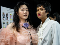 Models get ready backstage before walking on the runway during Day 2 of Bangkok International Fashion Week at Siam Paragon in Bangkok, Thail...