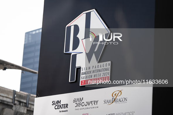 A general view of the Bangkok International Fashion Week and sponsor logos is on display at the venue. Models get ready backstage before wal...