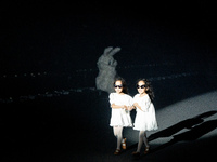 Twin models run from a rabbit on the runway during Day 2 of Bangkok International Fashion Week at Siam Paragon in Bangkok, Thailand, on Octo...