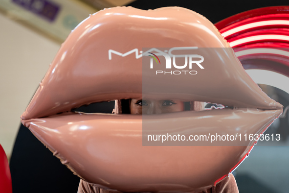 A representative of MAC cosmetics dresses up as a set of lips during Day 2 of Bangkok International Fashion Week at Siam Paragon in Bangkok,...