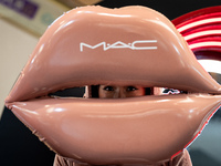 A representative of MAC cosmetics dresses up as a set of lips during Day 2 of Bangkok International Fashion Week at Siam Paragon in Bangkok,...