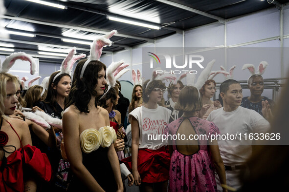 Models wear bunny ears and celebrate after showcasing creations by TandT on the runway during Day 2 of Bangkok International Fashion Week at...