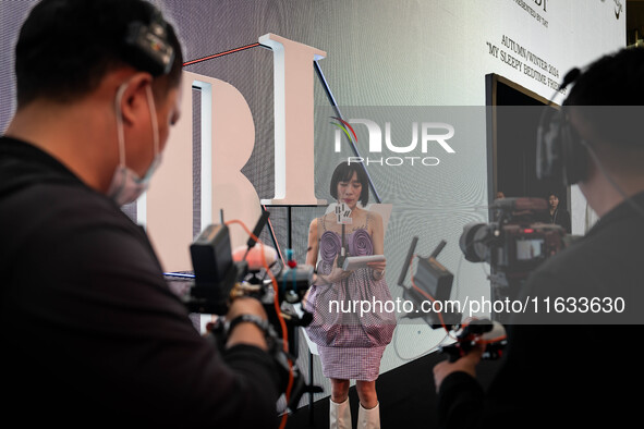 A host conducts a live broadcast outside of the runway during Day 2 of Bangkok International Fashion Week at Siam Paragon in Bangkok, Thaila...