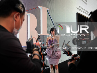 A host conducts a live broadcast outside of the runway during Day 2 of Bangkok International Fashion Week at Siam Paragon in Bangkok, Thaila...