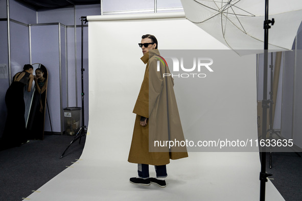 Models get ready backstage before walking on the runway during Day 2 of Bangkok International Fashion Week at Siam Paragon in Bangkok, Thail...