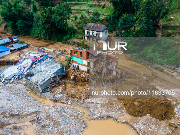 The aerial view shows the flood-affected areas of Patikharka, Kavrepalanchok District, Nepal, on October 3, 2024. Homes are severely damaged...