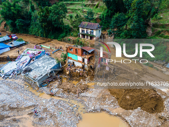 The aerial view shows the flood-affected areas of Patikharka, Kavrepalanchok District, Nepal, on October 3, 2024. Homes are severely damaged...