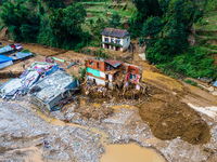 The aerial view shows the flood-affected areas of Patikharka, Kavrepalanchok District, Nepal, on October 3, 2024. Homes are severely damaged...