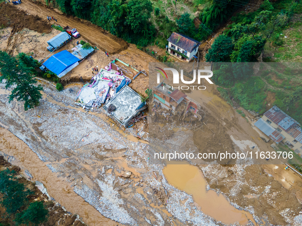 The aerial view shows the flood-affected areas of Patikharka, Kavrepalanchok District, Nepal, on October 3, 2024. Homes are severely damaged...