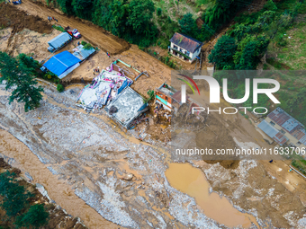 The aerial view shows the flood-affected areas of Patikharka, Kavrepalanchok District, Nepal, on October 3, 2024. Homes are severely damaged...