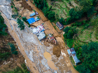 The aerial view shows the flood-affected areas of Patikharka, Kavrepalanchok District, Nepal, on October 3, 2024. Homes are severely damaged...