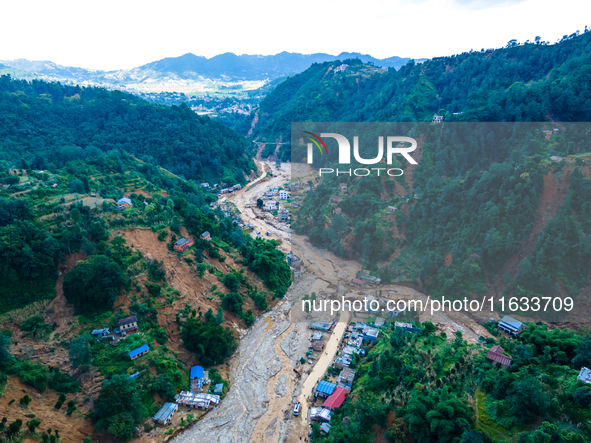 The aerial view shows the flood-affected areas of Patikharka, Kavrepalanchok District, Nepal, on October 3, 2024. Homes are severely damaged...