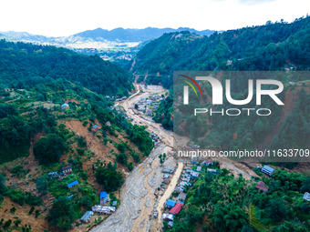 The aerial view shows the flood-affected areas of Patikharka, Kavrepalanchok District, Nepal, on October 3, 2024. Homes are severely damaged...