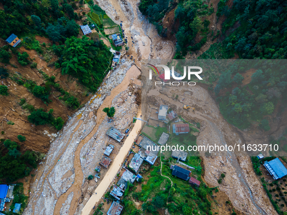 The aerial view shows the flood-affected areas of Patikharka, Kavrepalanchok District, Nepal, on October 3, 2024. Homes are severely damaged...