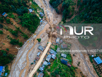 The aerial view shows the flood-affected areas of Patikharka, Kavrepalanchok District, Nepal, on October 3, 2024. Homes are severely damaged...