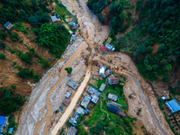 The aerial view shows the flood-affected areas of Patikharka, Kavrepalanchok District, Nepal, on October 3, 2024. Homes are severely damaged...